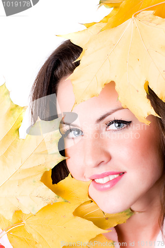 Image of young woman with yellow leaves 