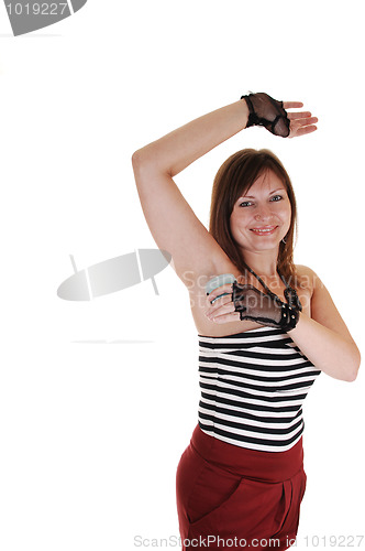 Image of Girl putting deodorant on.