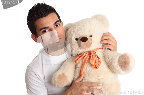 Image of Affectionate man holding bear