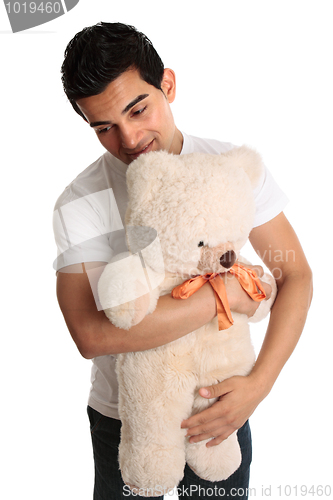 Image of Man hugging a teddy