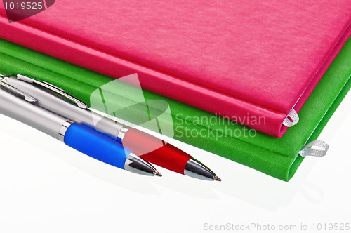 Image of Pencil with a notebook. A close up