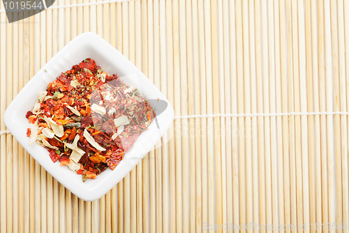 Image of Spice mixture for soup in dish on mat
