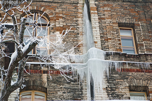 Image of Greater icicles hang down from a wall of the old house