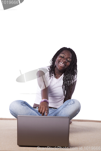 Image of young african woman working with her laptop