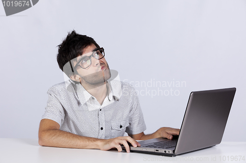 Image of Young man working with his laptop