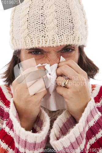 Image of woman sneezing to a tissue