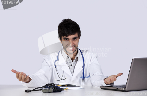 Image of frendly young doctor at his office