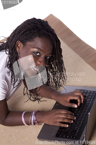 Image of young african woman working with her laptop