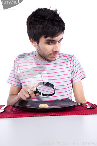 Image of Man looking to a peanut