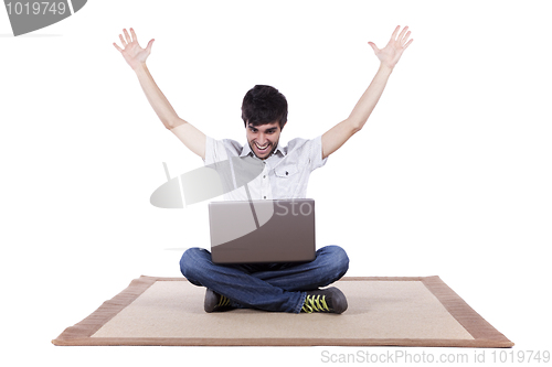 Image of Happy young man surfing the internet