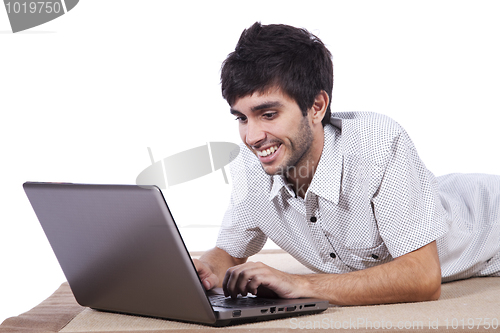 Image of Happy young man surfing the internet