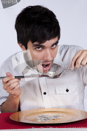 Image of Man eating little dollar banknote