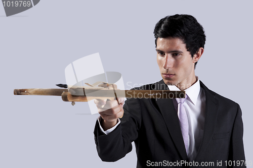 Image of Businessman aiming with a Crossbow