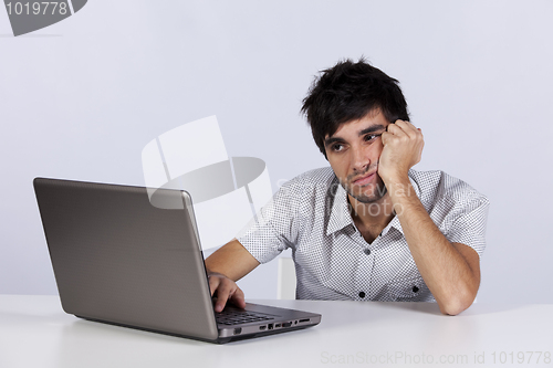 Image of Young working with his laptop