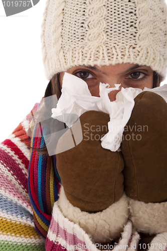 Image of woman sneezing to a tissue