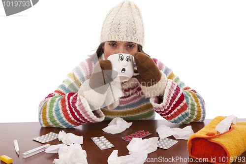 Image of woman with flu symptoms drinking a hot drink