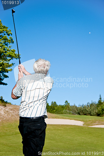 Image of Golfer watching his ball in the air