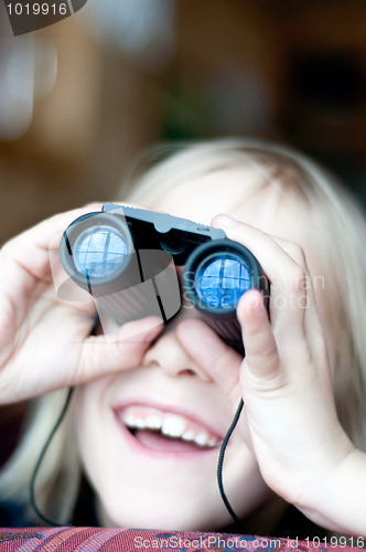 Image of Young girl looking trought binoculars