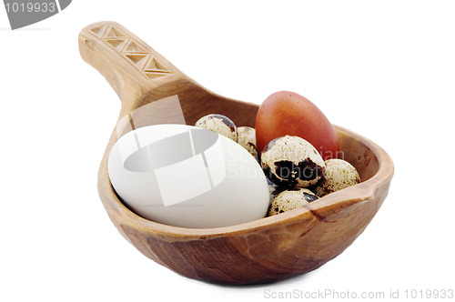 Image of Eggs in a wooden ladle