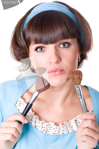 Image of  brunet woman with two make-up brushes 