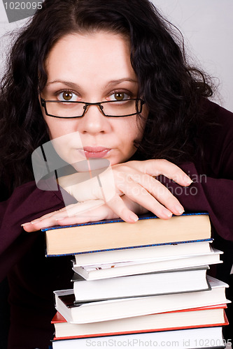 Image of attractive woman with stack of books