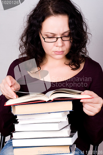 Image of woman with stack of books