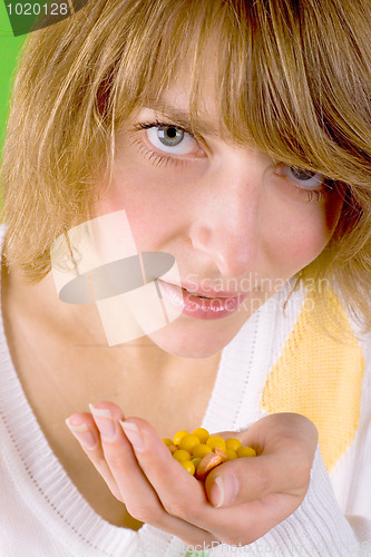 Image of woman with heap of yellow pills