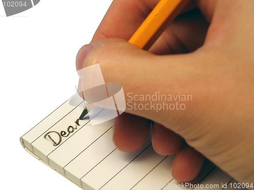 Image of Someone writing 'Dear' in a notebook.
