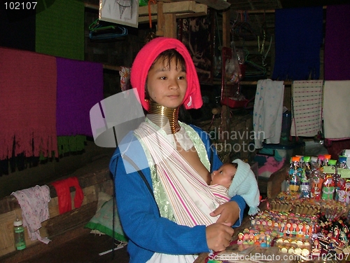 Image of longneck woman feeding her baby