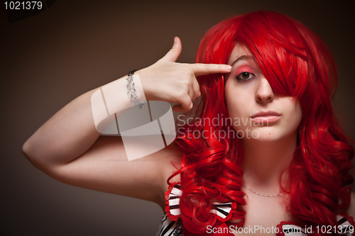 Image of Attractive Young Red Haired Woman with Hand To Her Head 