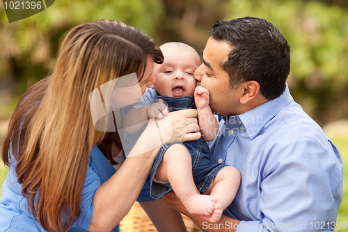 Image of Happy Mixed Race Parents Playing with Their Son