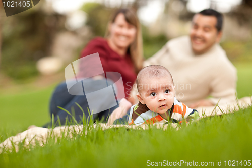 Image of Happy Baby Boy and Mixed Race Parents Playing in the Park