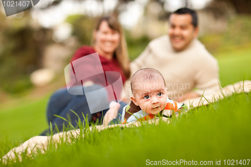 Image of Happy Baby Boy and Mixed Race Parents Playing in the Park