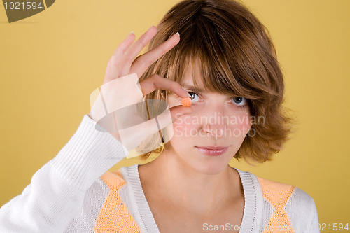 Image of young woman with pill