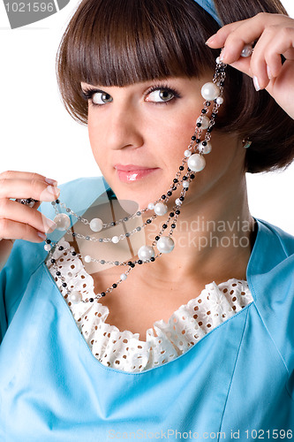Image of woman in blue dress with pearl beads