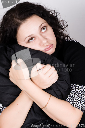 Image of pretty woman holding a pillow