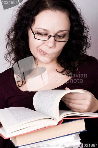 Image of woman with stack of books