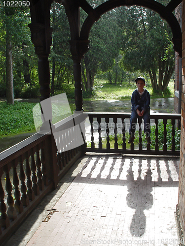 Image of Boy and his shadow at sunny rainy day