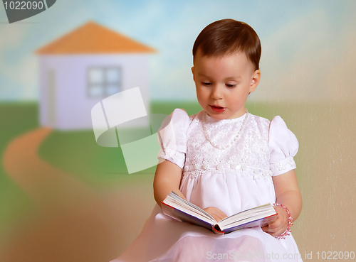 Image of Girl reading in a white dress