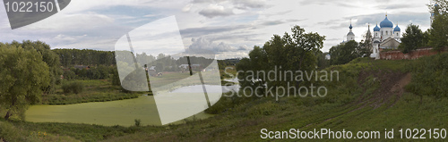 Image of Summer around blue and white monastery.