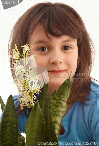 Image of Smiling girl with blossom flower.