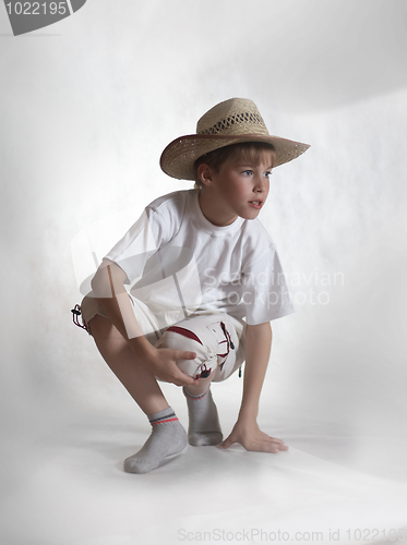 Image of Sitting boy straw hat