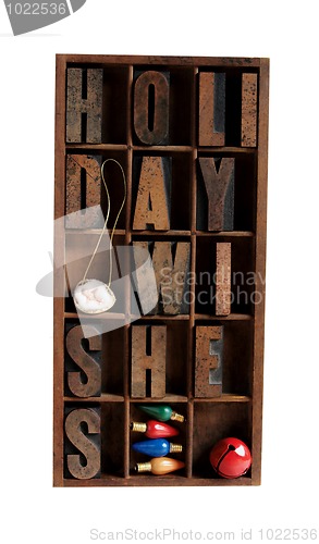 Image of holiday wishes in letterpress type in an old wood case