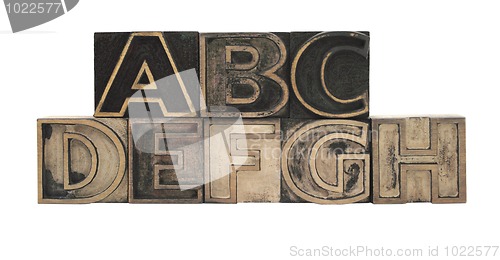 Image of outline letters in wood A-H