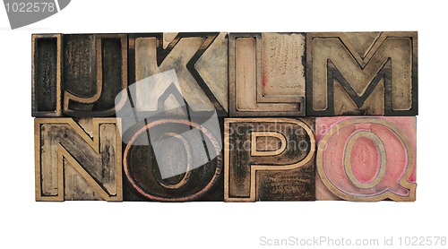 Image of outline letters in wood I - Q
