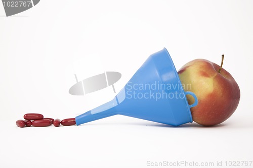 Image of blue funnel, apple and pills