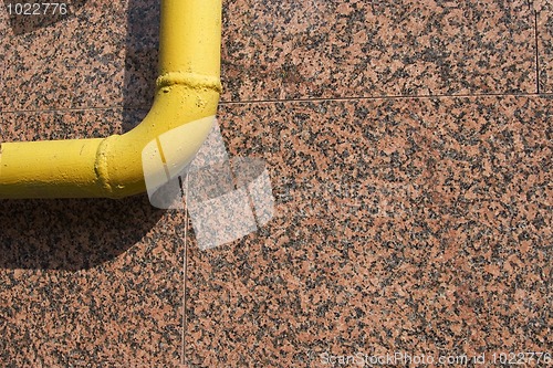 Image of yellow pipe on marble background