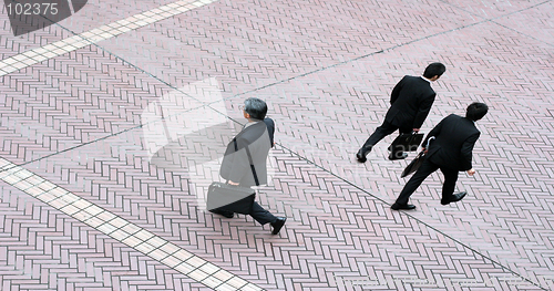 Image of Three business men walking