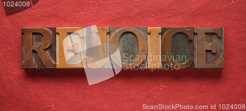 Image of the word rejoice in old wood type on red