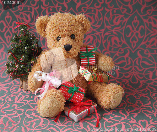 Image of teddy bear with Christmas presents